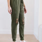 Kick Back Distressed Joggers In Olive