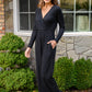 Onward & Upward Faux Wrap Jumpsuit In Black