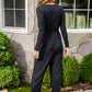 Onward & Upward Faux Wrap Jumpsuit In Black